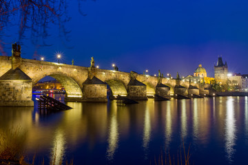Fototapeta na wymiar Night over Carlos bridge over Vltava river in Prague - Czech Republic