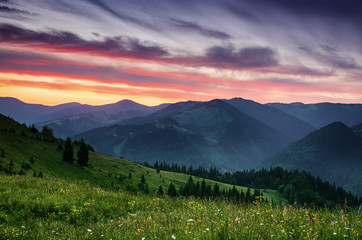 Carpathian mountains summer sunset landscape with dramatic sky and blue mountains