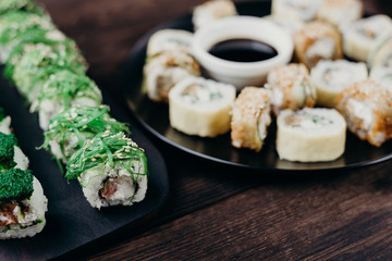 Japanese diet, seafood, property nutrition. Appetizing sushi rolls set on plate, selective focus
