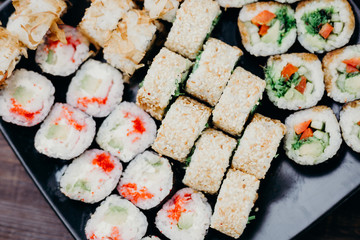 Restaurant menu, Japanese food art. Appetizing maki sushi set, served on black plate
