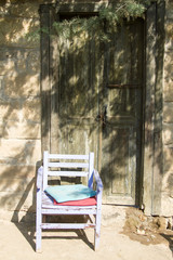 Fototapeta na wymiar Old chair in front of old door