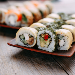 Japanese restaurant menu, professional culinary, traditional meals. Delicious sushi rolls with eel, salmon and cheese, close up. Delicious meals for foodie