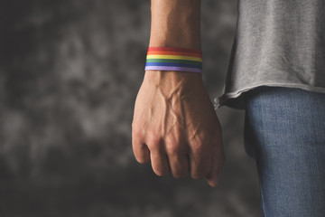 man with a rainbow-patterned ribbon in his wrist