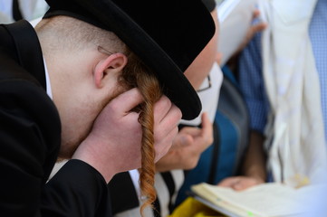 Religious Jews pray at the Western Wall in Jerusalem. Prayer of the Coens in honor of the Jewish holiday Pesach