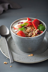 granola and yogurt with seeds and strawberry for breakfast