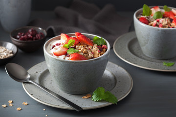 granola and yogurt with seeds and strawberry for breakfast