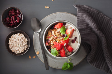 granola and yogurt with seeds and strawberry for breakfast