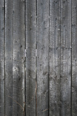 Grungy background of peeling flaking black paint on wooden boards