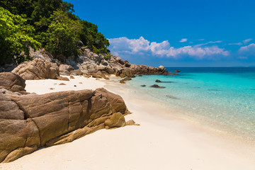 Beautiful stretch of a fine soft white sandy beach, turquoise blue shimmering water, big rocks &...