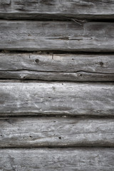 Obraz premium Rough old weathered log cabin background wall closeup