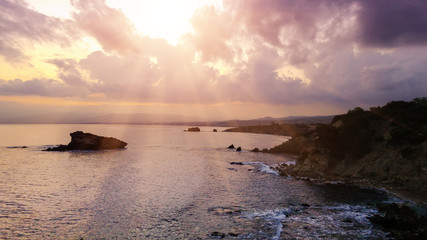 Cyprus beautiful sunrise at the sea with rocks and cloudy sky, natural panoramic background. Summer vacation concept