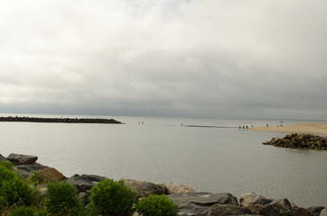 Fototapeta na wymiar Island with cloudy sky background. Coastline, water