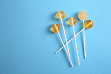 Delicious lollipops on color background