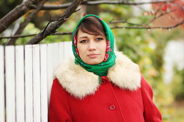 Portrait of young woman in red coat. Vintage photo.
