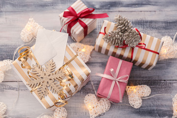 Beautiful Christmas gift boxes with decorations on wooden table