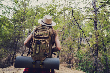 Trekking with backpack in the forest