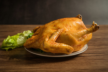 Roast chicken on the wooden table