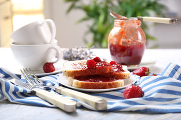 Composition with slices of bread and delicious strawberry jam on light table