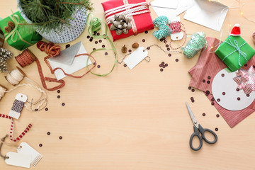 Beautiful Christmas gift boxes and packing materials on light table
