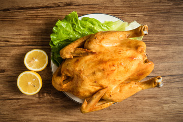 Roast chicken on the wooden table