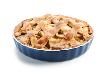 Dish with delicious apple pie on white background