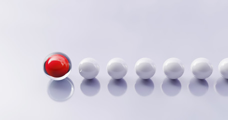Konzept zu Führung einer Gruppe. Rote Kugel als Symbol für einen Anführer, der ein Team bei einem Wettbewerb anführt.