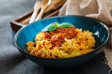 tasty fusilli pasta Italian meat sauce pasta on the table