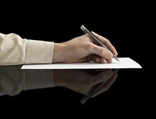 Pen in hand Isolated on grey background (clipping path)