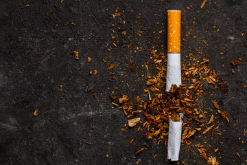 Cigarettes, tobacco on a black background. Treatment of nicotine addiction. Danger to life. Smoking concept