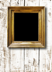 Old vintage gold ornate frame for picture on  wall