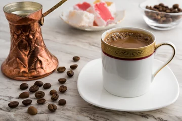 Foto auf Acrylglas Vintage cup of turkish coffee and traditional bronze coffee pot served on marble with turkish delights © dinosmichail