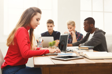 Woman using laptop at modern office
