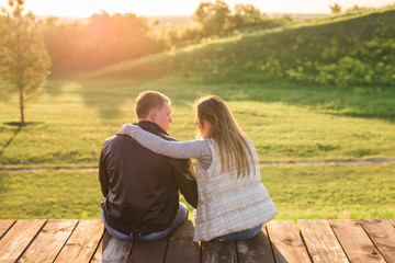 Love couple hugging in autumn nature back view