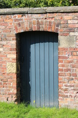 old wooden door in brick wall