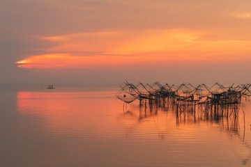 Fishing net tools in the lake with beautiful morning twilight.