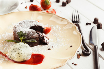 Chocolate fondant with vanilla ice cream and strawberry