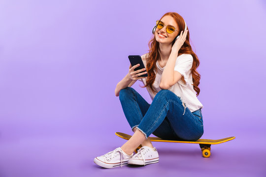 Full length portrait of a smiling young girl in sunglasses - Powered by Adobe