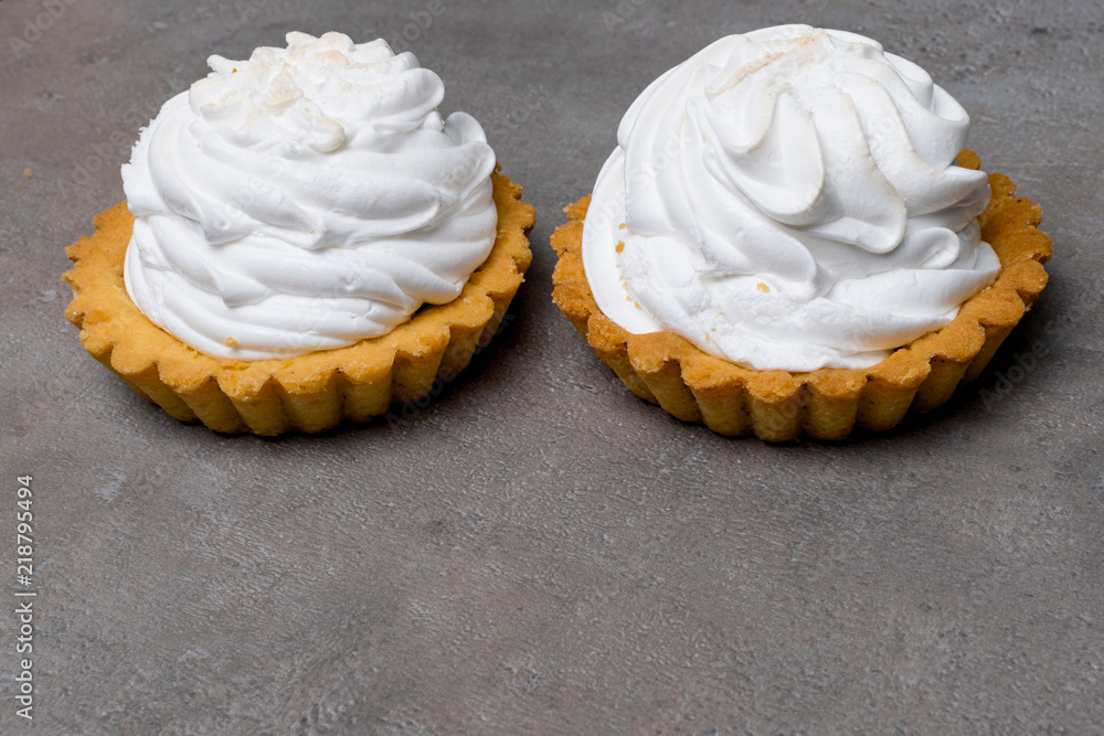 Wall mural delicious merengue dessert. lemon tartlet tart with with meringue on grey stone concrete table backg