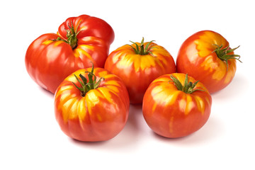 Fresh colorful sweet rustic tomatoes, isolated on white background.
