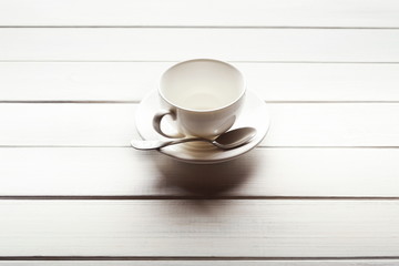 Fototapeta na wymiar Tea cup and saucer on wooden planks