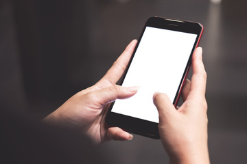 Cropped shot view of woman's hands holding smart phone with blank copy space screen for your text message or information content.