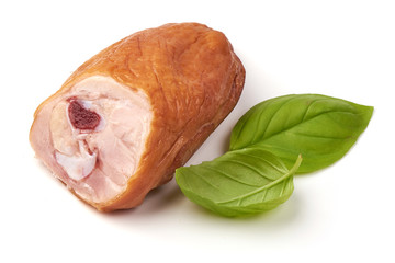 Smoked chicken leg with basil leaves, isolated on white background.