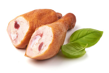 Smoked chicken legs with basil leaves, isolated on white background.