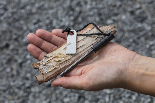 Fire steel and a piece of birch bark in a woman's hand in Finland.