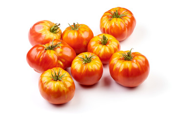 Fresh colorful sweet rustic tomatoes, isolated on white background.