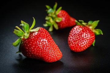 Fresh organic Strawberries, Three fruits on black elegant background