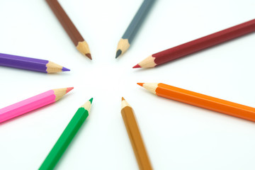 Colorful wooden pencils surround a circle on a white background. Make a center Can be used as background or fill in text with copy spaces.