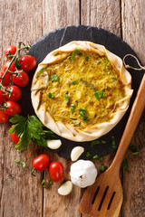 Vegetable potato open pie closeup and ingredients. vertical top view