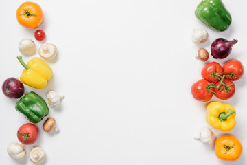 top view of ripe bell peppers, tomatoes and garlic isolated on white