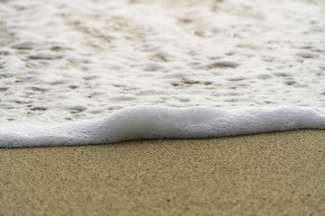 Soft wave of ocean on the beach. with copy space for your text message. Selective focus.